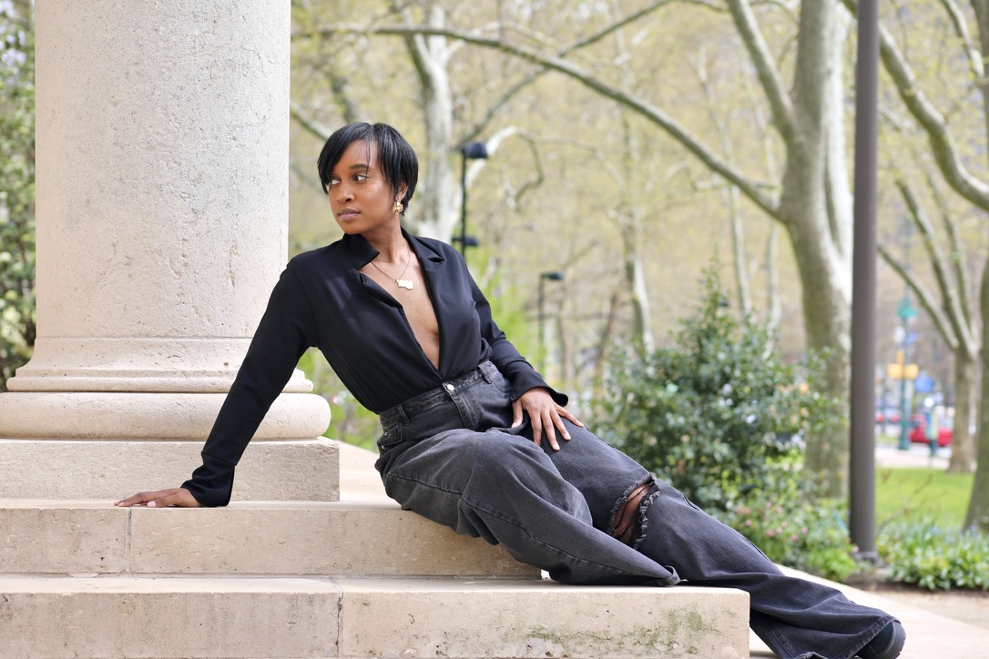 Tiffani Kennard reclining against stone columns