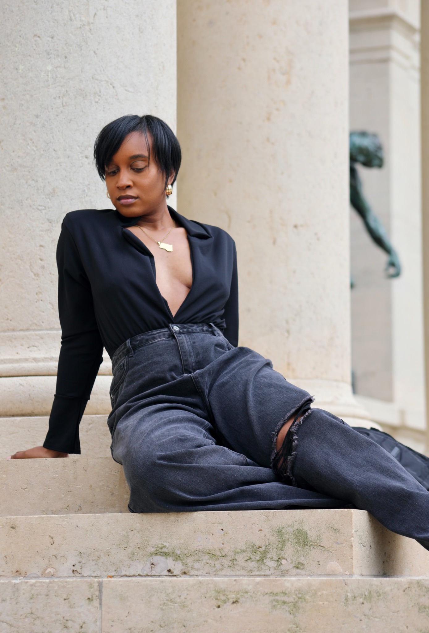 Tiffani Kennard seated against monumental stone columns